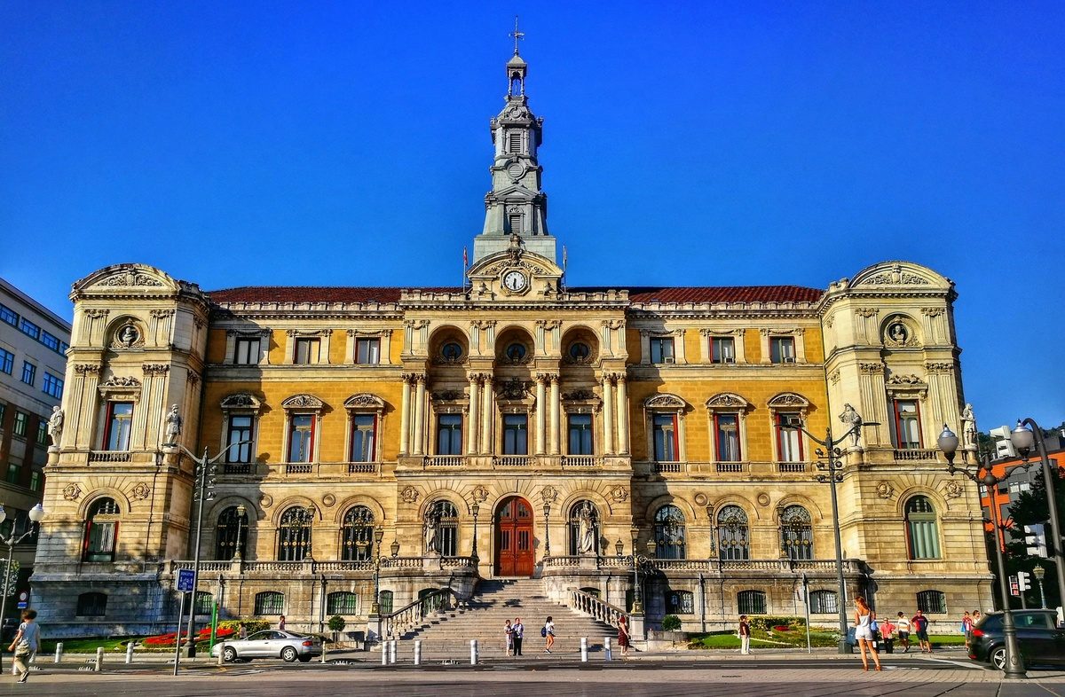 The yellow city hall of Bilbao under a blue sky